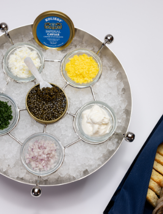 6 jars of caviars arranged over ice in a bowl