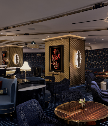 Interior seating area for Collins bar with art and chandeliers