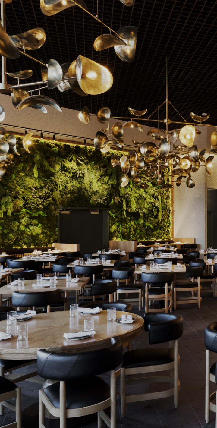Dining room set ready for customers, with wall of plants and art sculpture lamps above