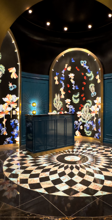 Hostess station of Papi Steak with bright artwork and marble tiling