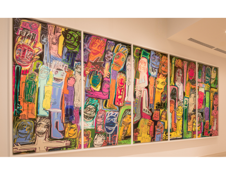 Colorful painting hung on a blank white wall