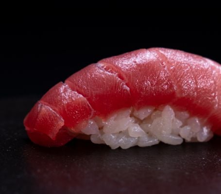 Piece of fish sitting on rice
