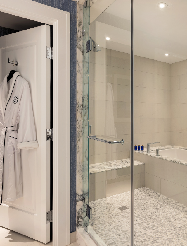 Shower area with robe hanging off open door
