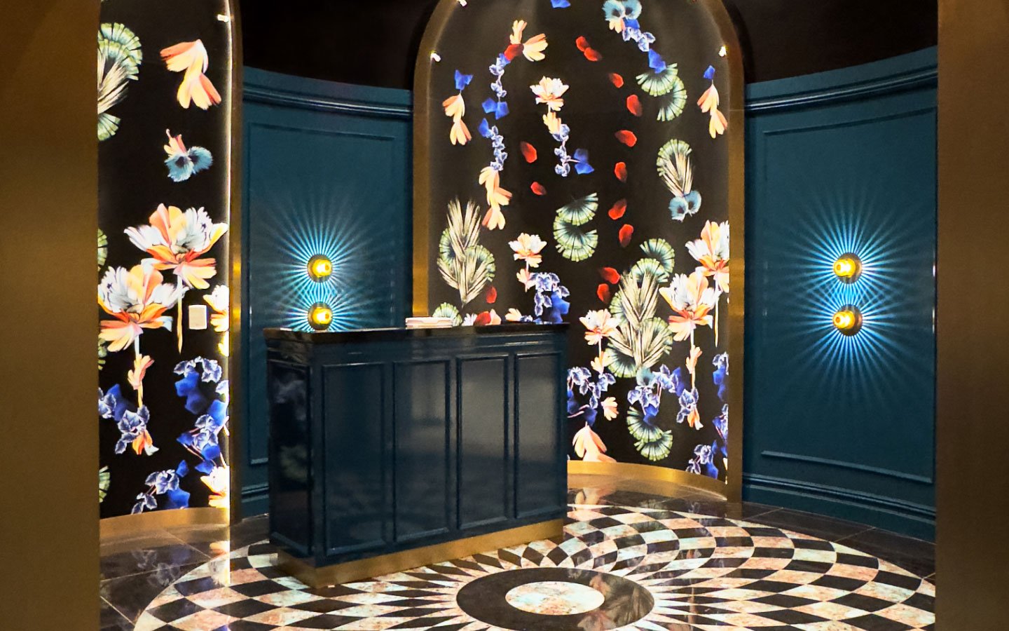 Hostess station of Papi Steak with bright artwork and marble tiling