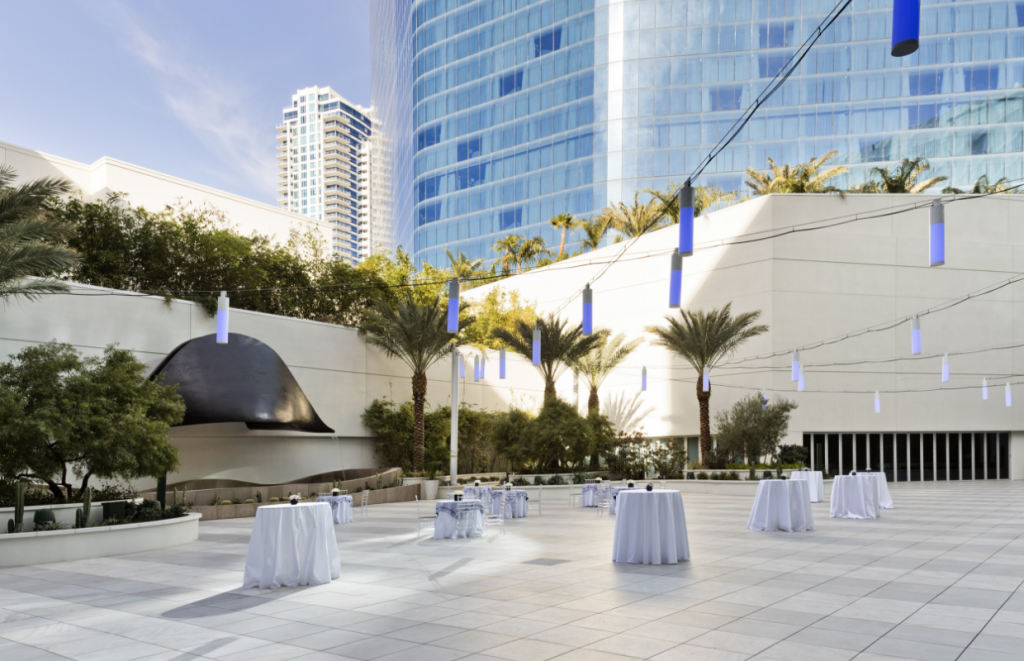 Outdoor venue space with art piece in center with surrounding foliage