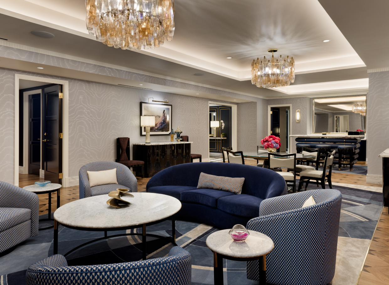Dining table, seating area underneath chandeliers