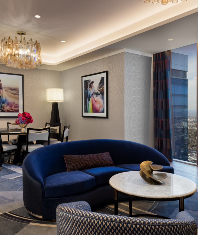 Dining table, seating area underneath chandeliers