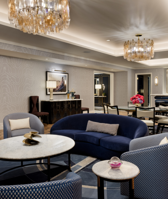 Dining table, seating area underneath chandeliers