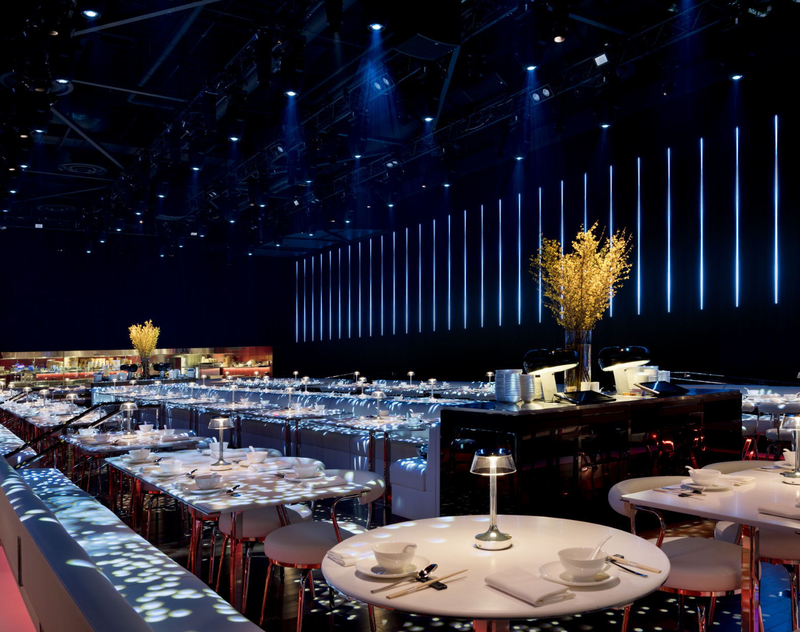 Interior of dining area with tan seats and tables with lighting above