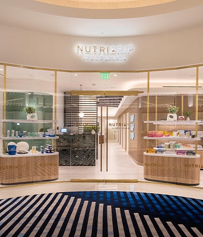 Nutridrip retail storefront with bottle displays framing the doors