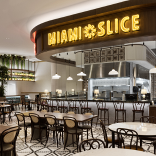 Miami Slice neon sign logo hanging in the quick service restaurant area with seating