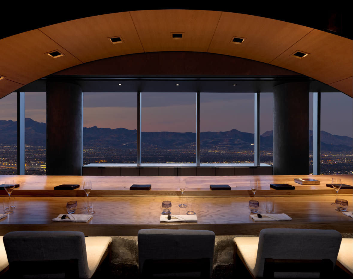 Seating area underneath curved lighting arch looking at a mountain vista