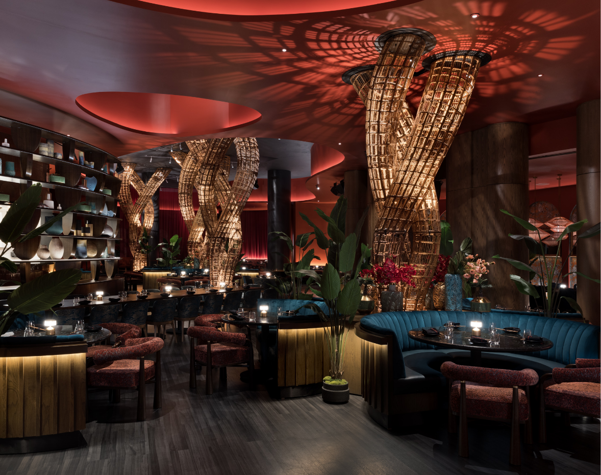 Uplit wire abstract sculpture surrounded by green booths and set tables