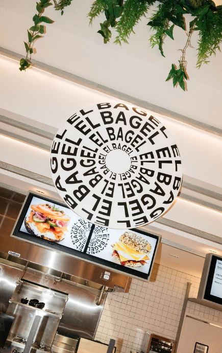 El Bagel sign logo hanging in the restaurant area