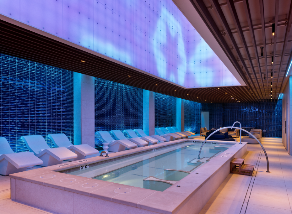 Blue pool room with white lounge chairs