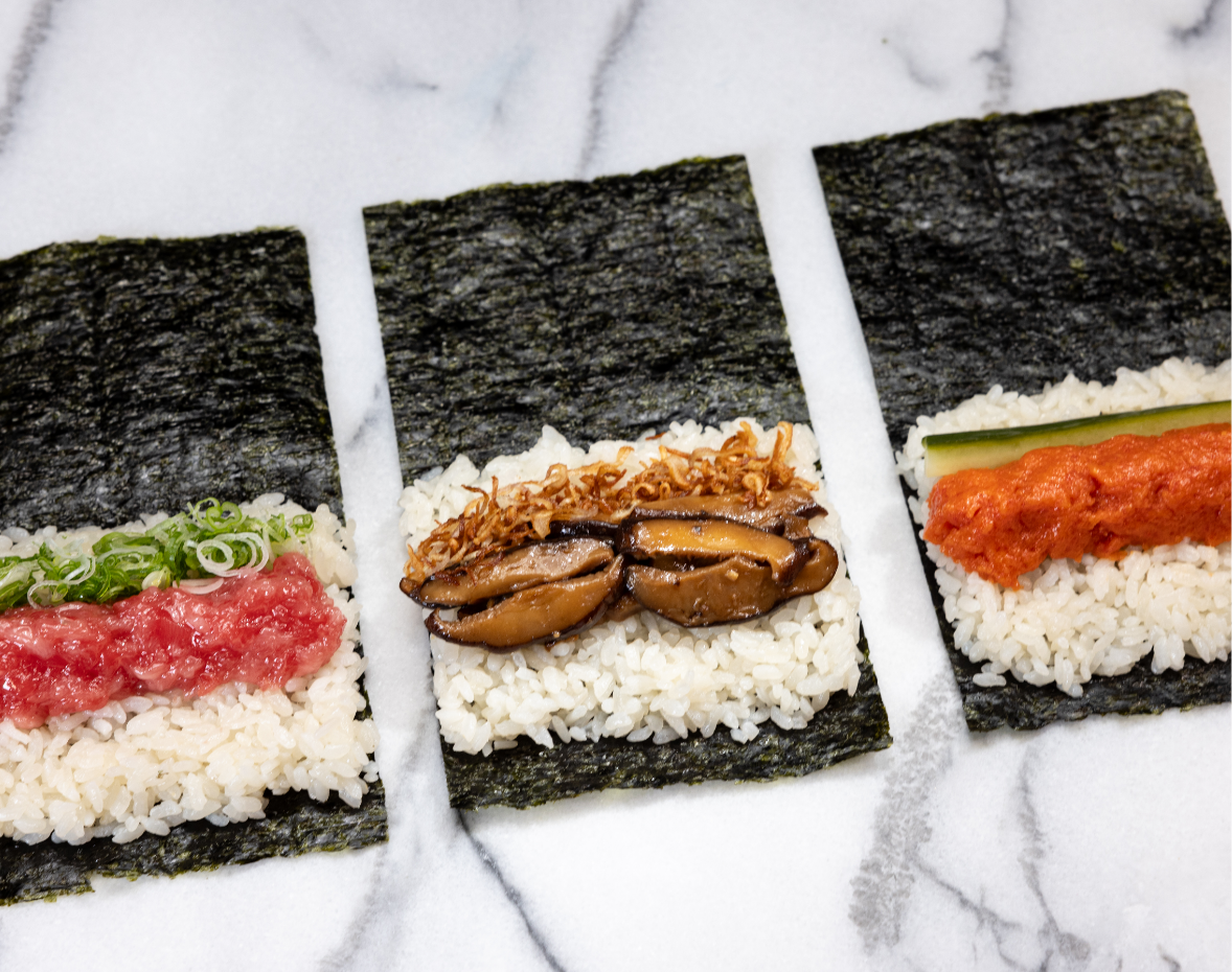 3 different pieces of sushi waiting to be finished by being wrapped in seaweed