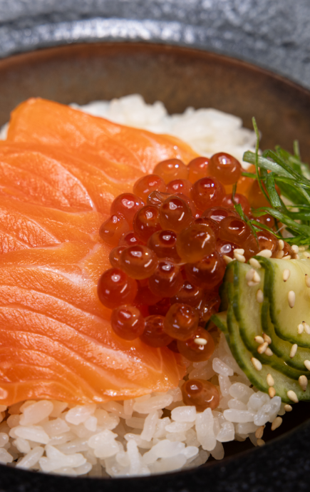 Salmon, Masago and cucumber over rice in a bowl