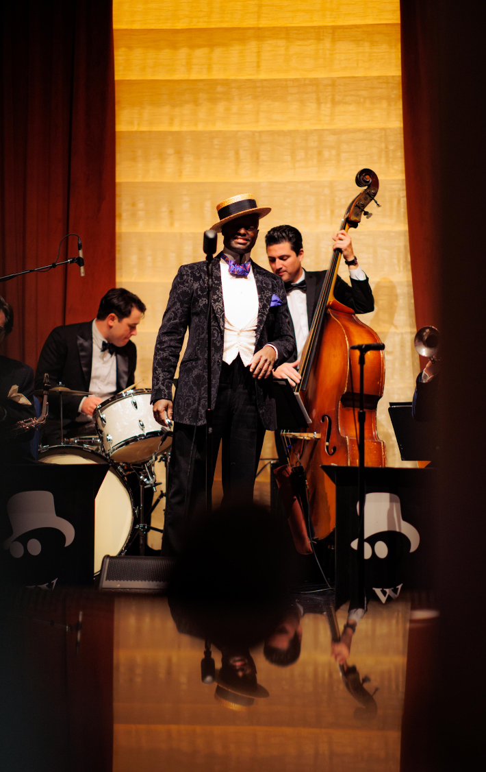 Band with singer, drummer and cello performing