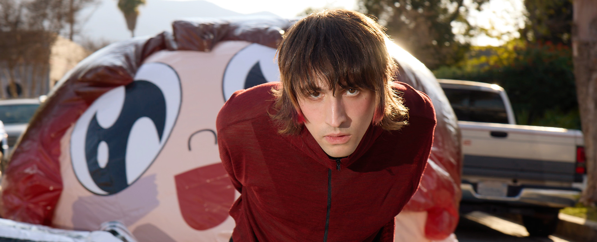 Porter Robinson dragging a balloon face behind him