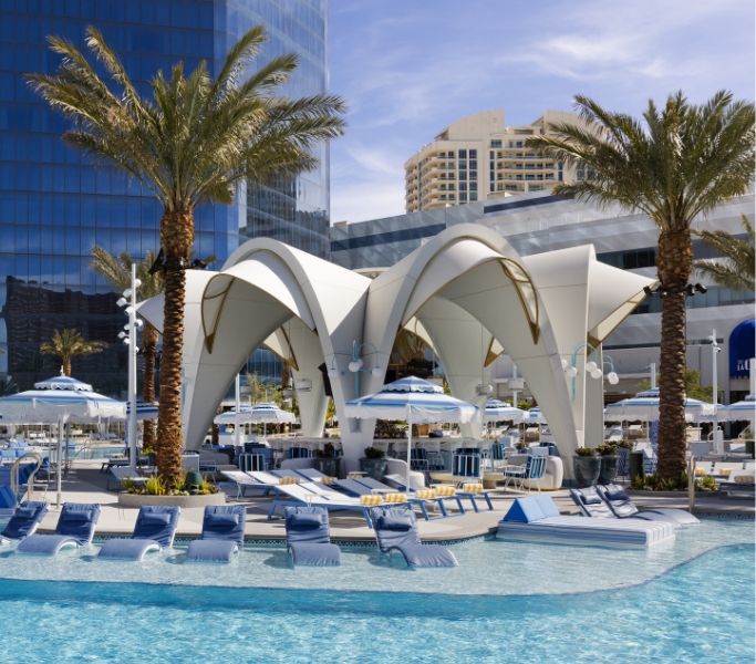Outdoor pool area with seating and arched architectural over bar