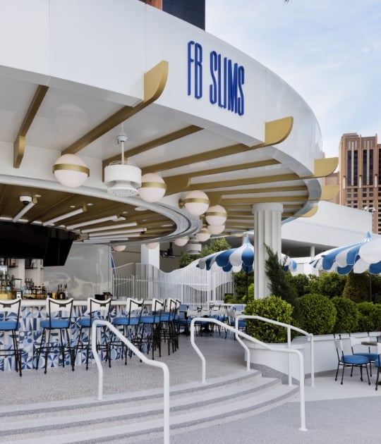 Exterior FB Slims sign above bar and seating area