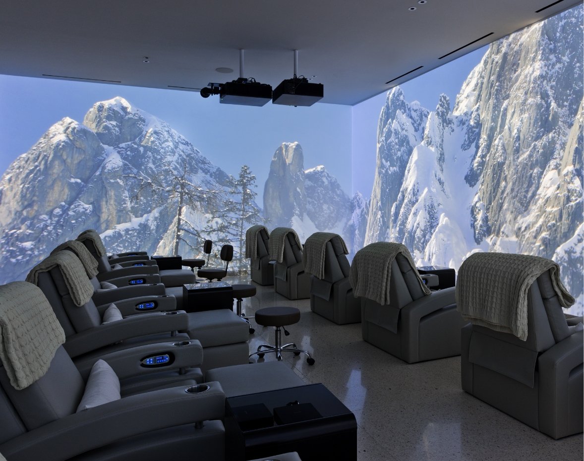 11 massage chairs surrounded by an LED projection of snow