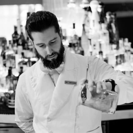 Man pouring a drink in black and white