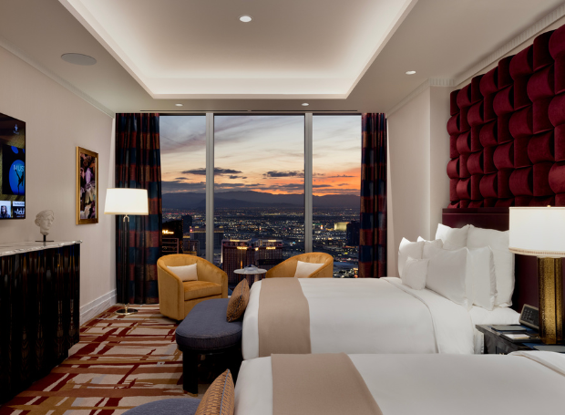 2 beds in a bedroom with an entertainment center