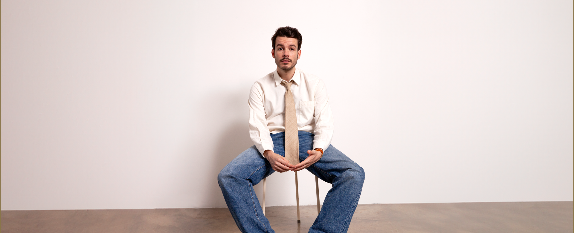 Rex Orange County sitting on a stool