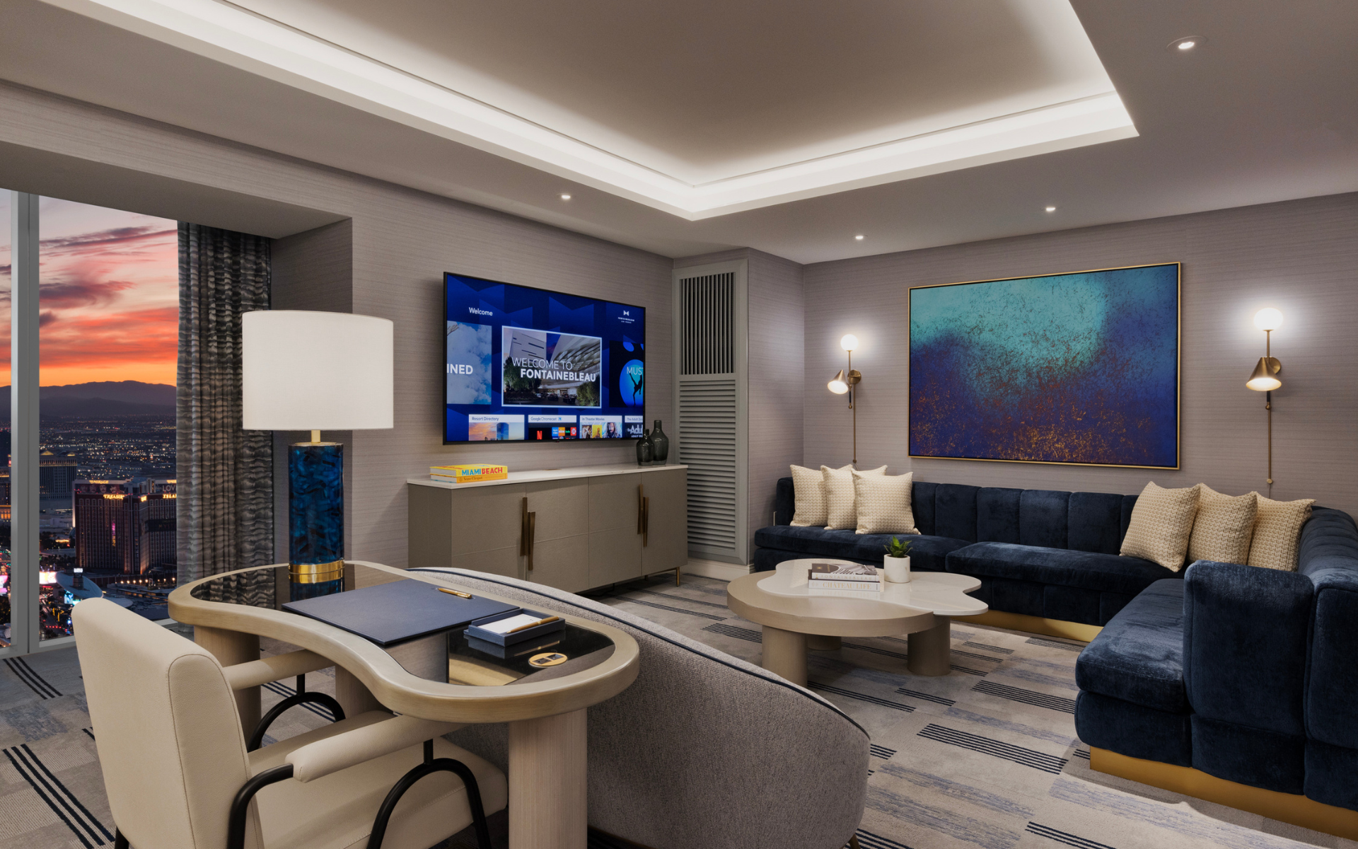 Seating areas with a chandelier, and art