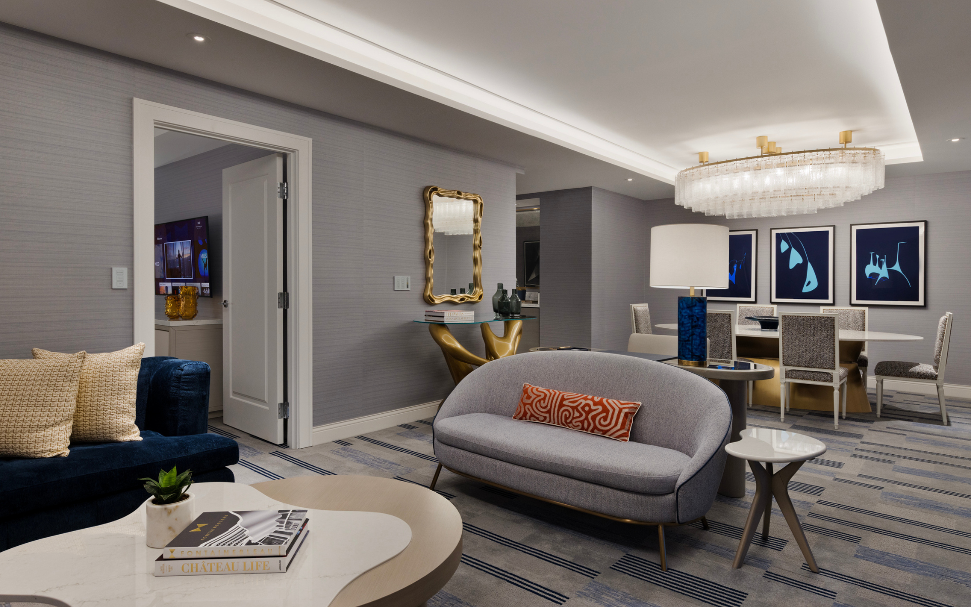 Dining and seating areas with a chandelier, and art