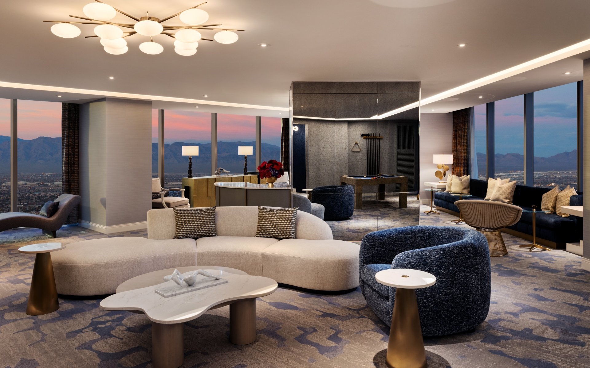 Seating area with mini bar, billiard table and chairs underneath a light fixture