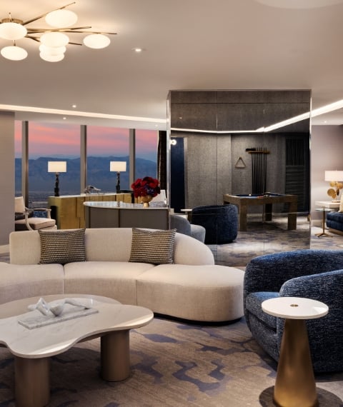 Seating area with mini bar, billiard table and chairs underneath a light fixture