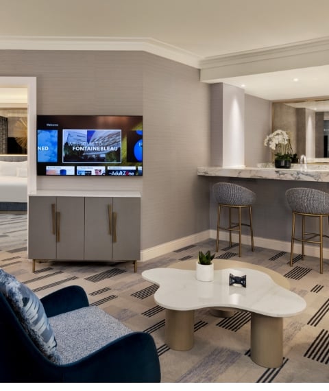 Seating area with mini bar, table and chairs underneath a light fixture