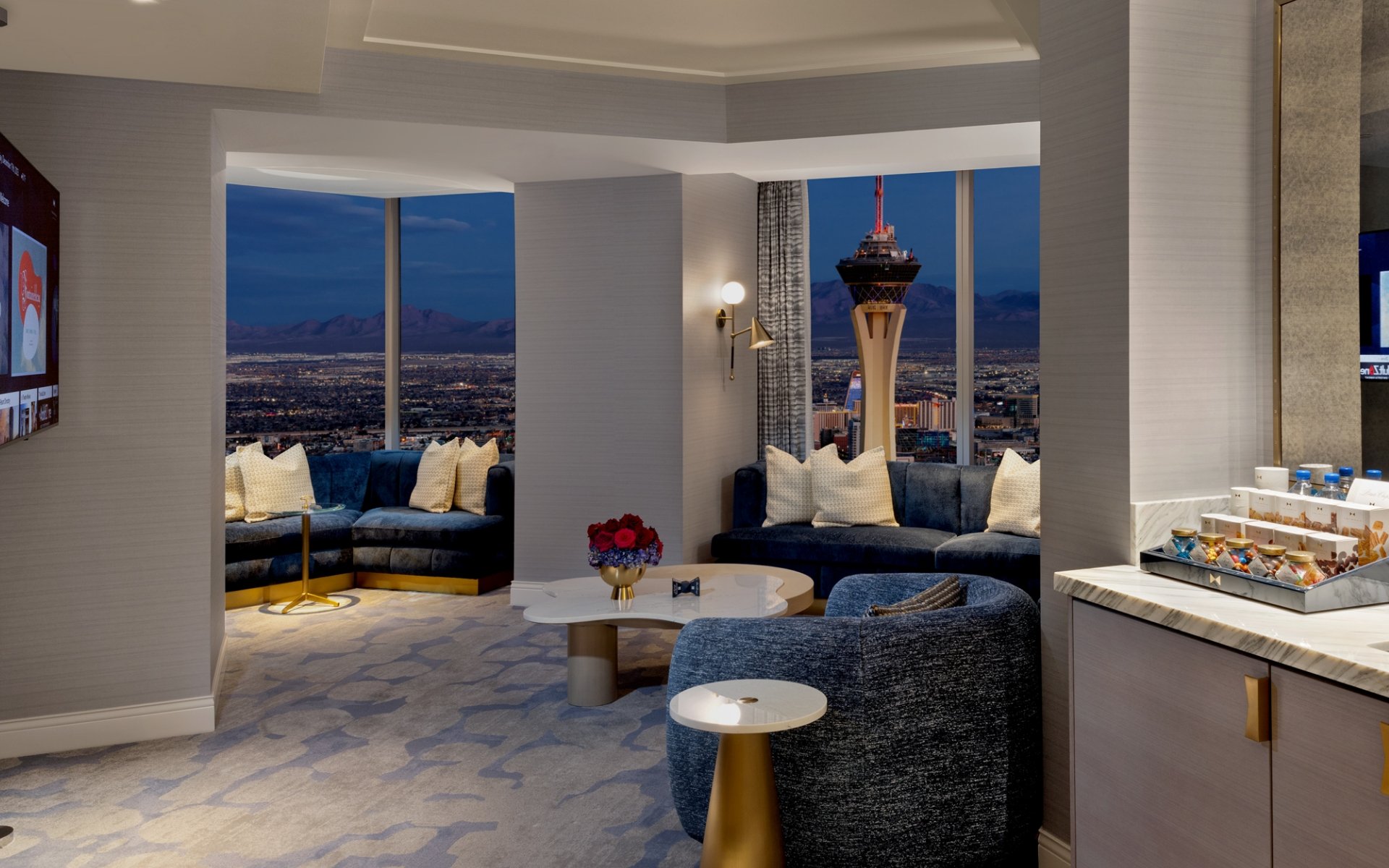 Seating area with mini bar, table and chairs underneath a light fixture