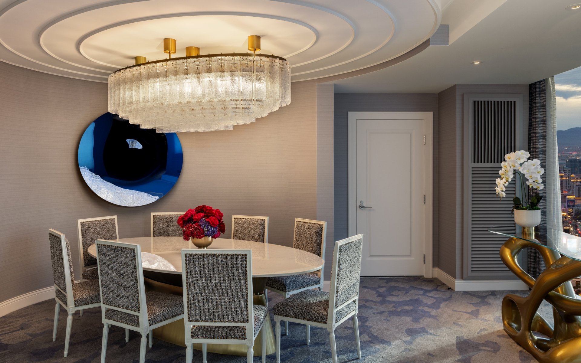 Dining table and chairs under chandelier