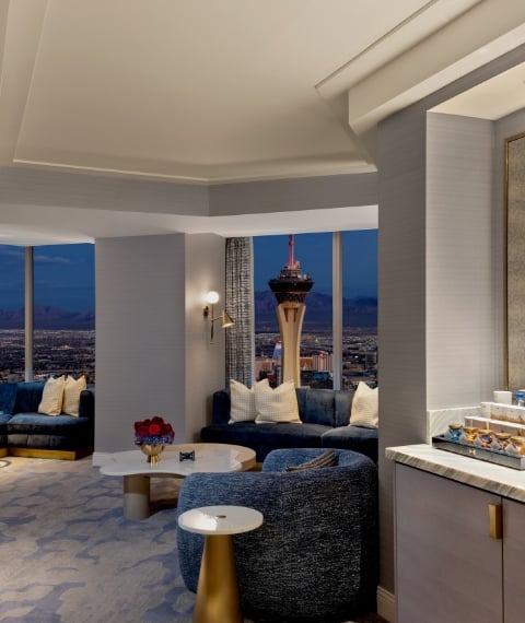 Seating area with mini bar, table and chairs underneath a light fixture