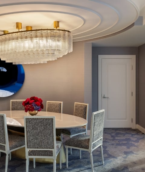 Dining table and chairs under chandelier