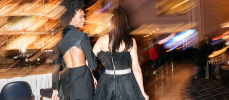 Two models walking through a casino with a blur effect