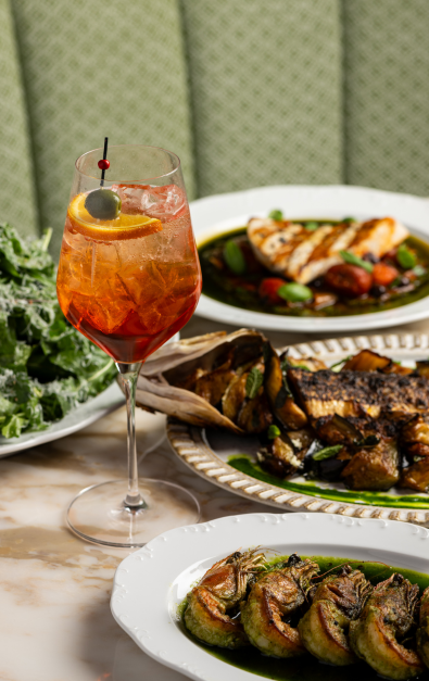 4 plates of food with a drink with a green background