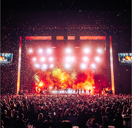 Crowded theater with pyrotechnics and lights