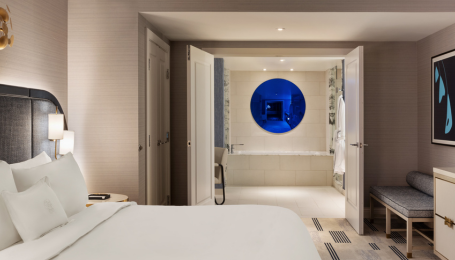 Bed and entryway to bathroom