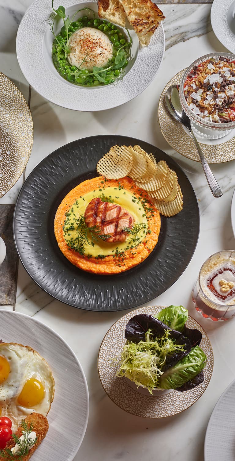 Full table of food against a white marble background