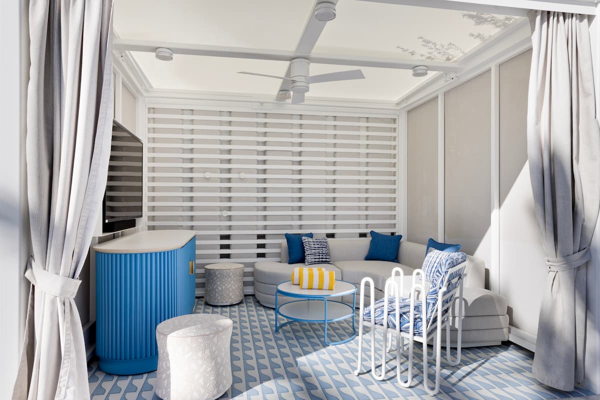 Outdoor seating area with fan, television, pillows and towels