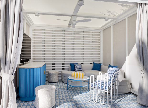 Outdoor seating area with fan, television, pillows and towels