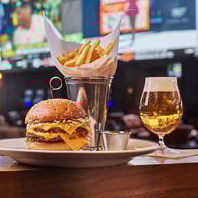 Plate of burger, fries, and beer from The Tavern