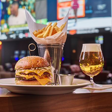 Plate of burger, fries, and beer from The Tavern