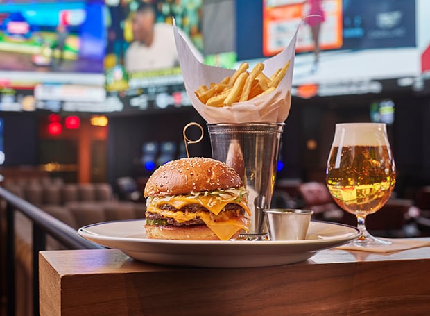 Plate of burger, fries, and beer from The Tavern