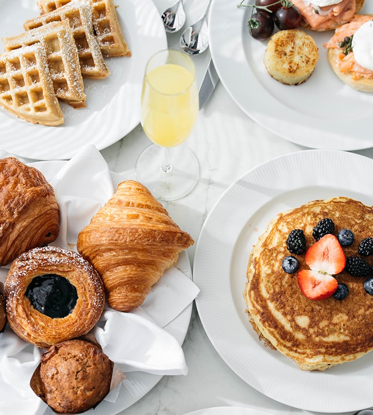 Plates of pancakes, croissant, and pastries for room service at Fontainebleau Las Vegas