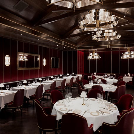 Interior tables in the red dining room at Don's Prime